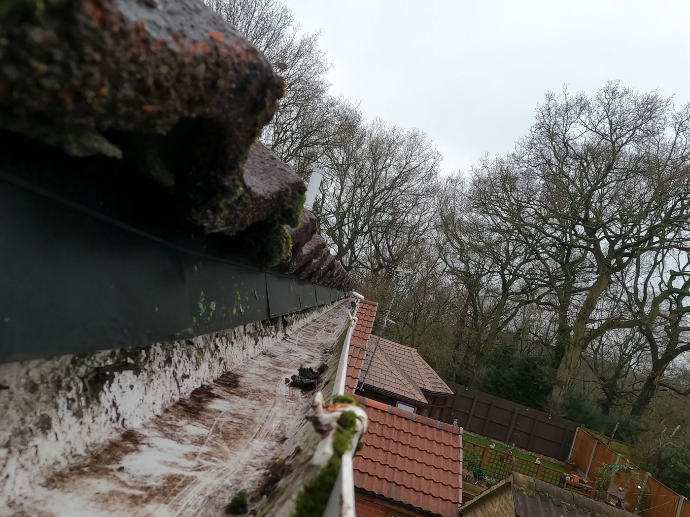 After: two-storey house on Gerrard Close, Arnold — gutter cleared of moss and plants, run open to the outlet