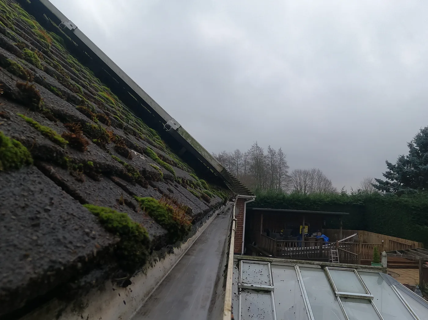 After: six-bedroom detached house on Woodchurch Road, Arnold — gutter cleared and open along the run above the conservatory