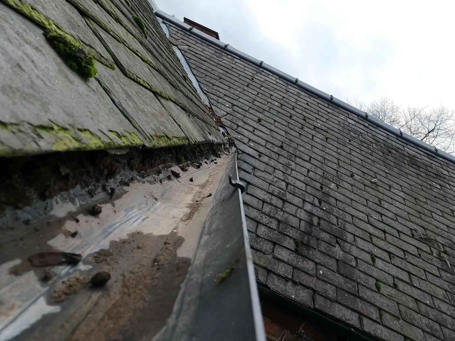 After: rear gutter of a Victorian terrace on Vernon Avenue, Old Basford, cleared to bare metal, looking up the slate roof valley